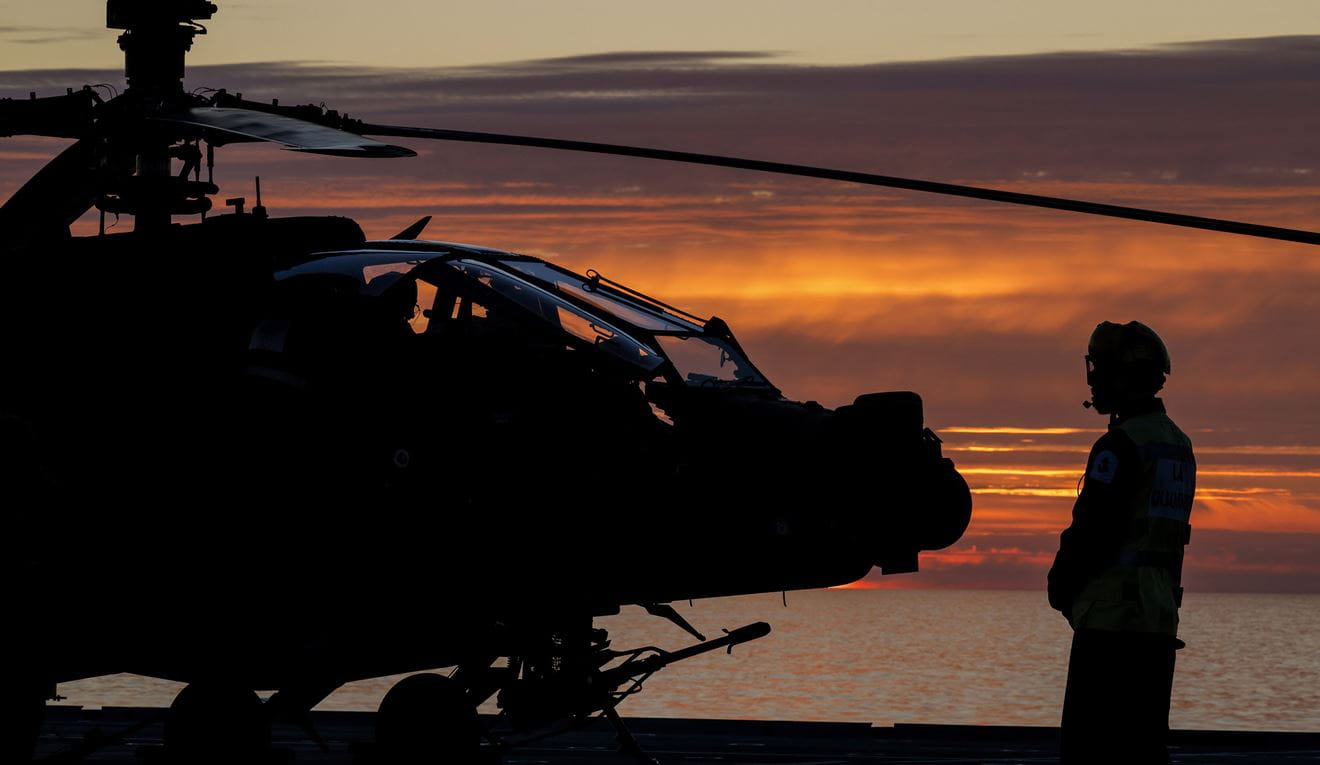 An Apache crew carries out pre-flight checks on the flight deck before a dawn sortie An Apache crew carries out pre-flight checks on the flight deck before a dawn sortie