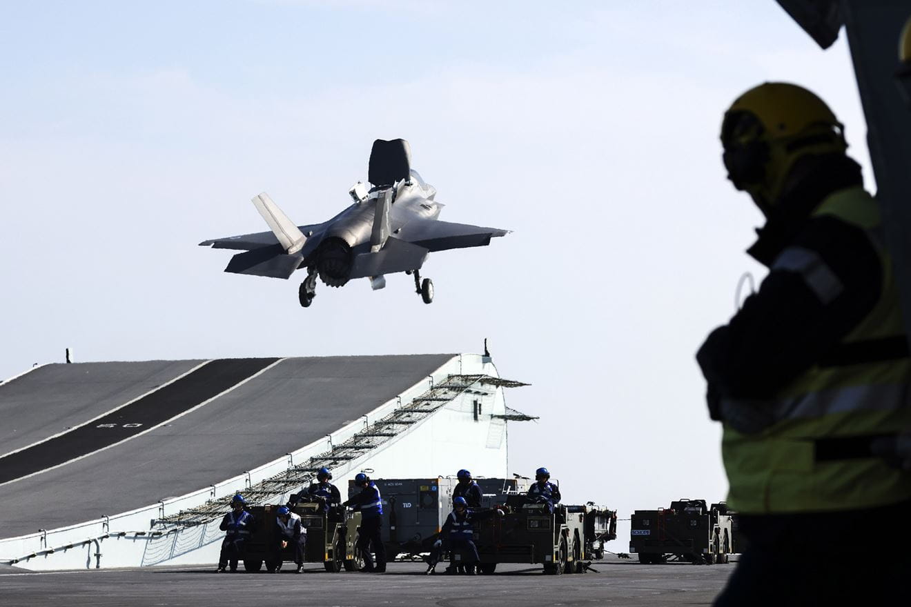 Aircraft Handlers watch as an F-35 takes off from HMS Prince of Wales Aircraft Handlers watch as an F-35 takes off from HMS Prince of Wales