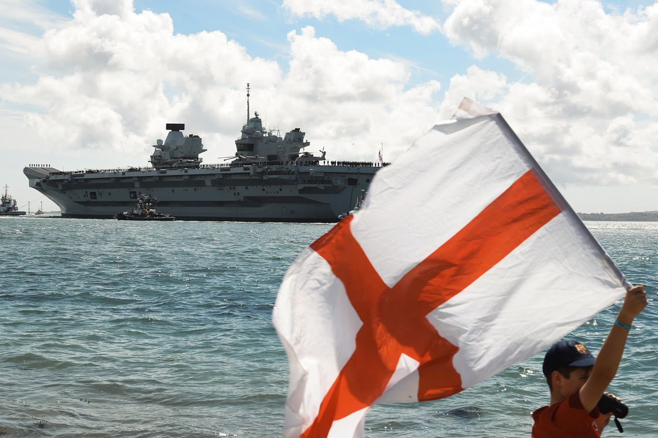 A youngster waves the Flag of St George as HMS Prince of Wales leaves Portsmouth in 2025 A youngster waves the Flag of St George as HMS Prince of Wales leaves Portsmouth in 2025