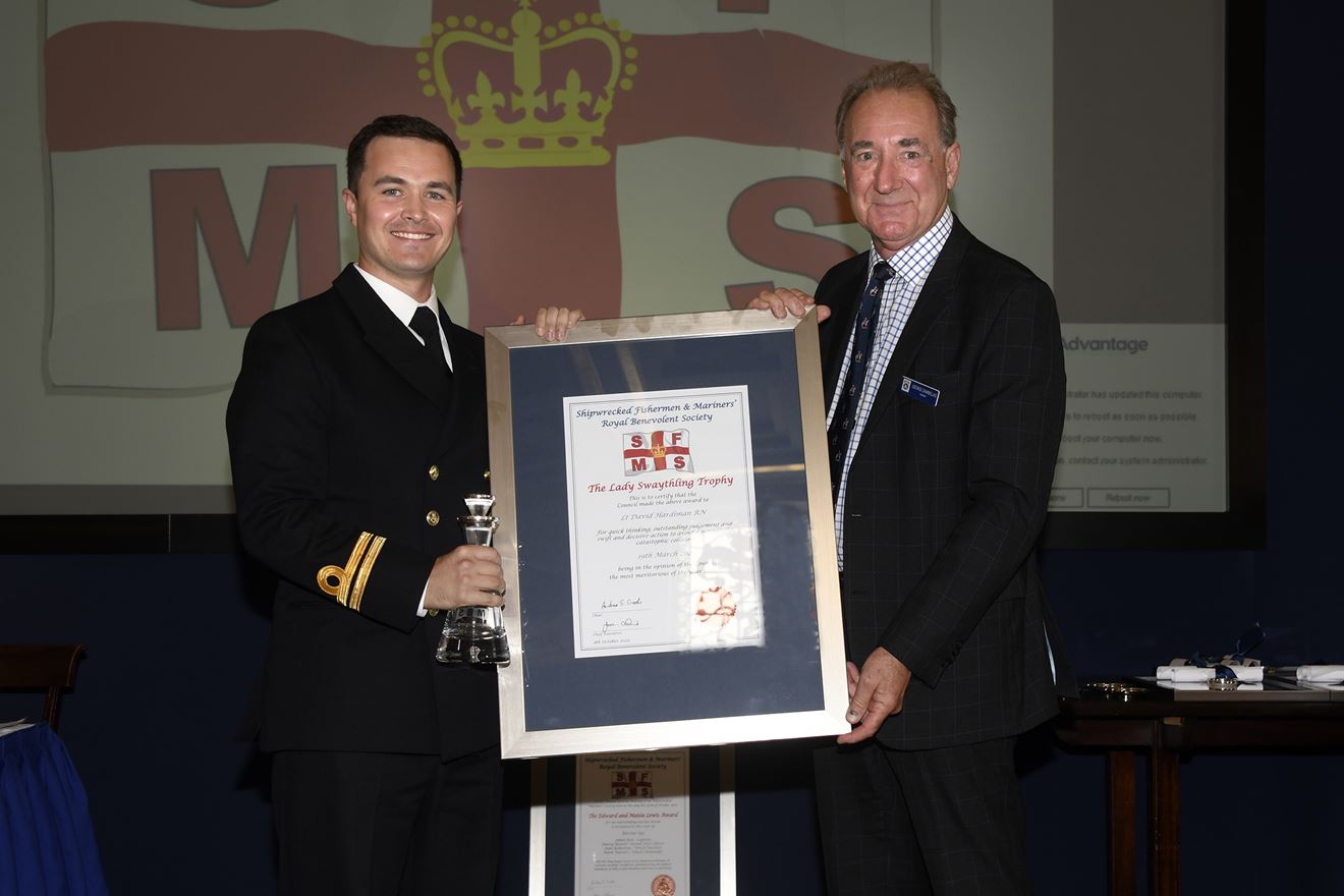 Lt David Hardiman receives his trophy and certificate from former First Sea Lord Admiral Sir George Zambellas