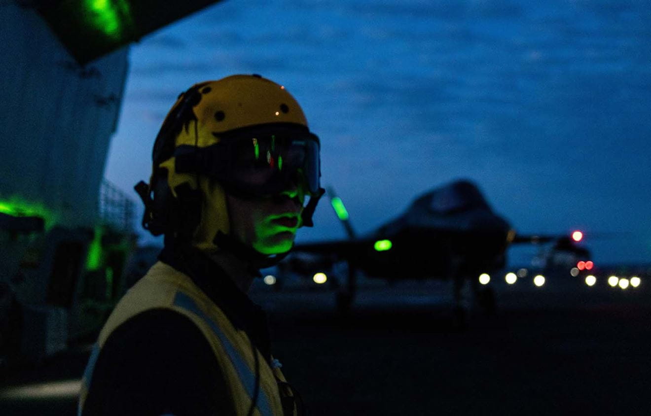 Aircrew on Prince of Wales flight deck with F-35 in background