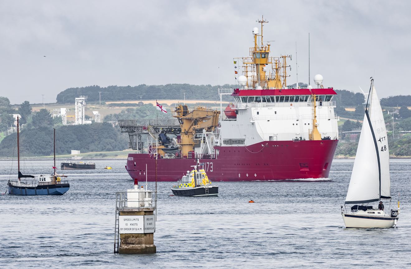 HMS Protector makes her way past yachts and a police launch HMS Protector makes her way past yachts and a police launch