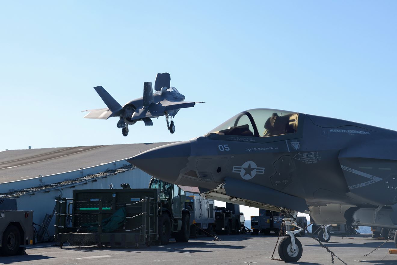 An Italian F-35 lifts of the ramp with a USMC Lightning parked in the foreground An Italian F-35 lifts of the ramp with a USMC Lightning parked in the foreground