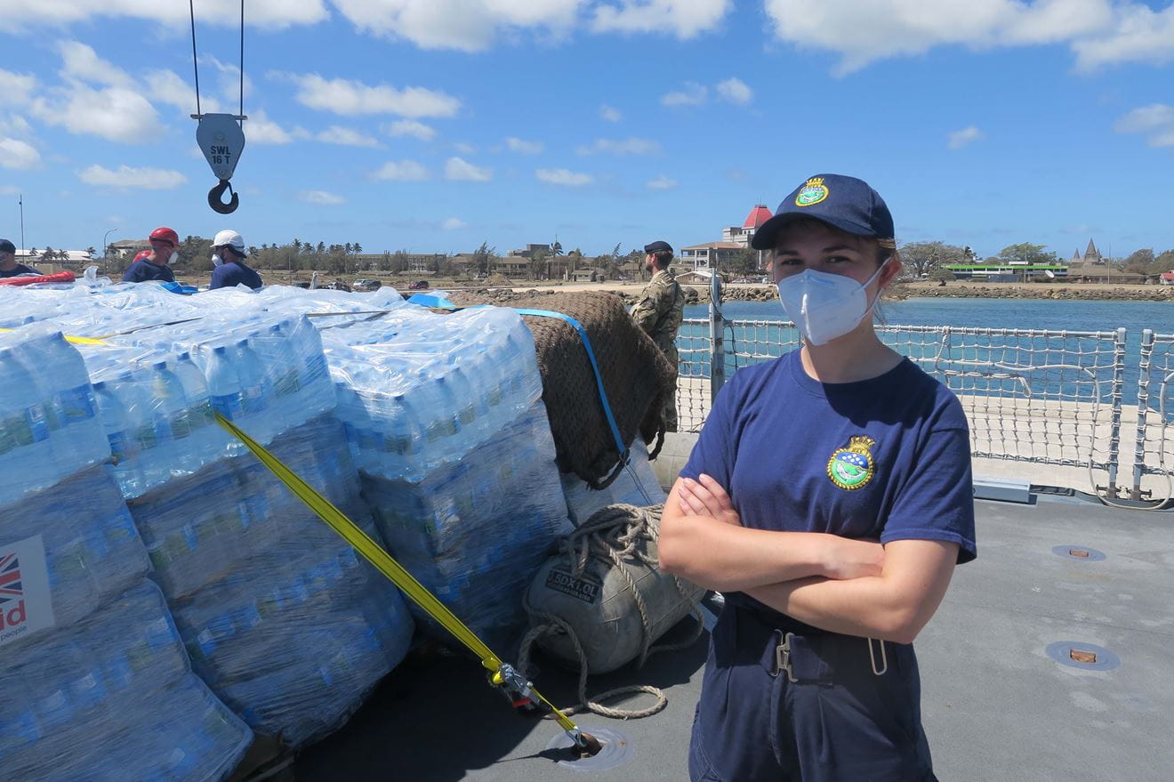 Sub Lt Kate Winter with piles of bottled water awaiting delivery Sub Lt Kate Winter with piles of bottled water awaiting delivery