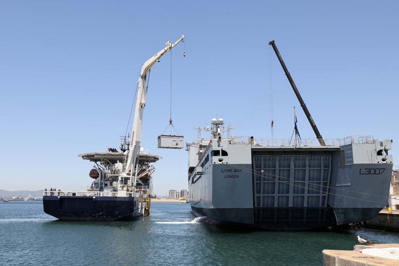 HMS Stirling Castle cranes equipment onto RFA Lyme Bay in Gibraltar