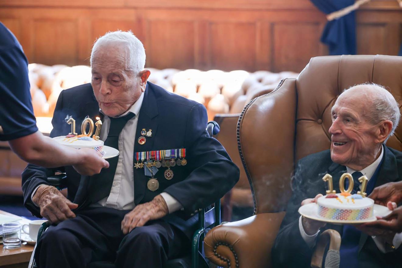 Robin Boodle tackles his birthday candles watched by Len Chivers