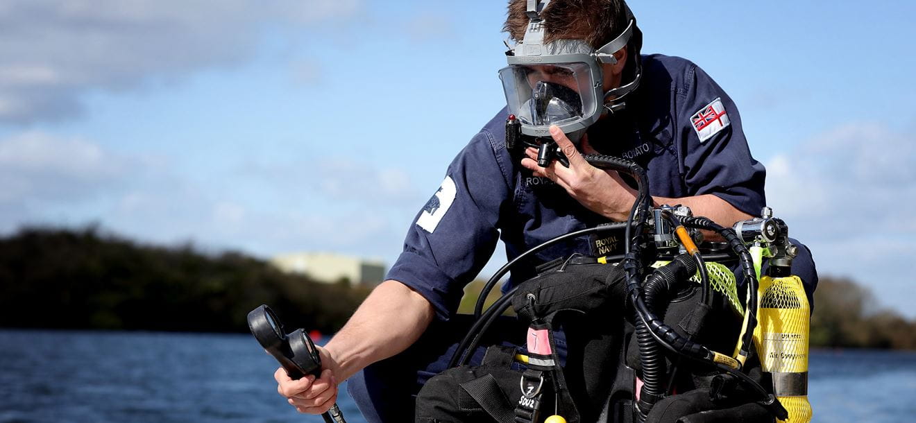 Diver conducting pre diving checks on his dive rig before boarding the RIB.