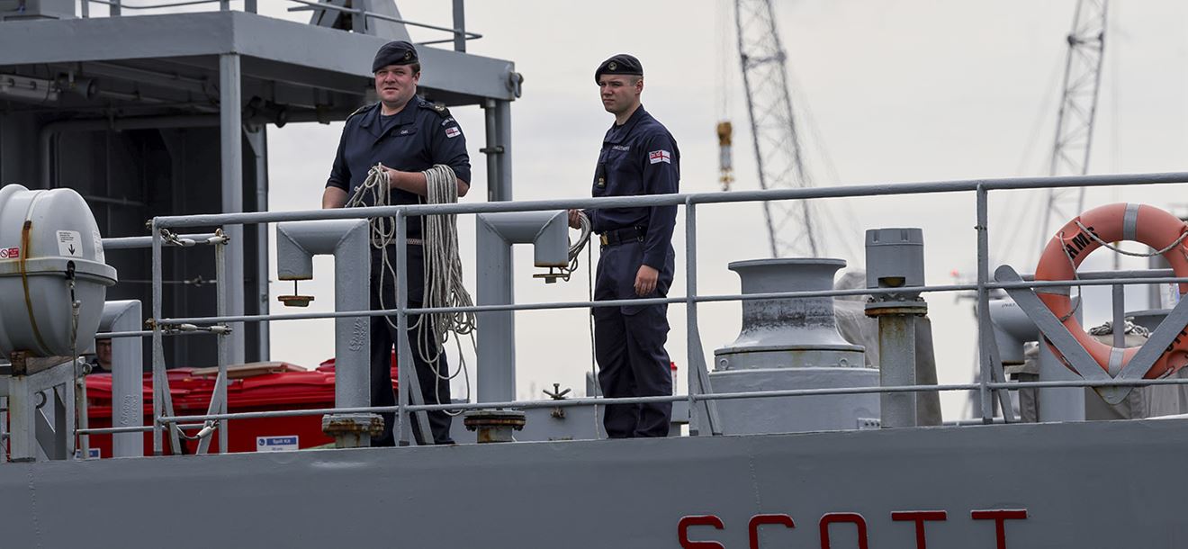 Two members of HMS Scott as she returns to Devonport.