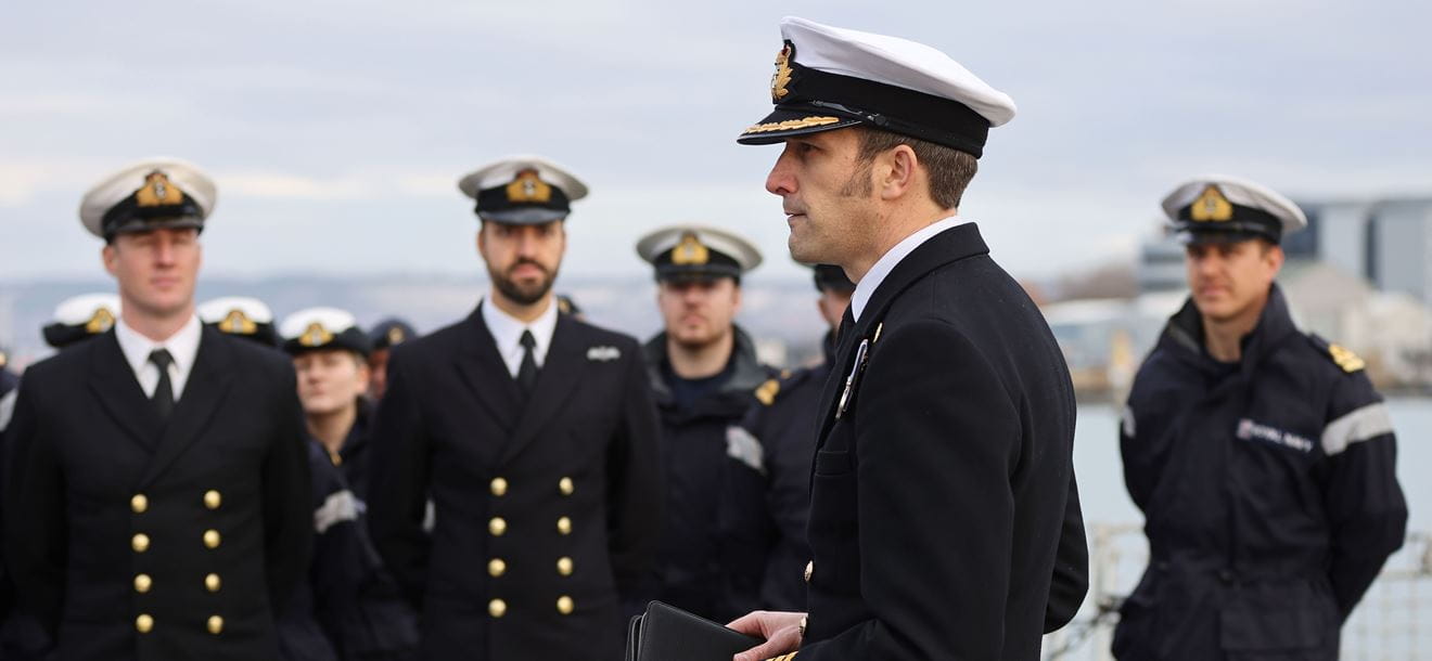 Commanding Officer of HMS Kent addresses the ships company on the flight deck.