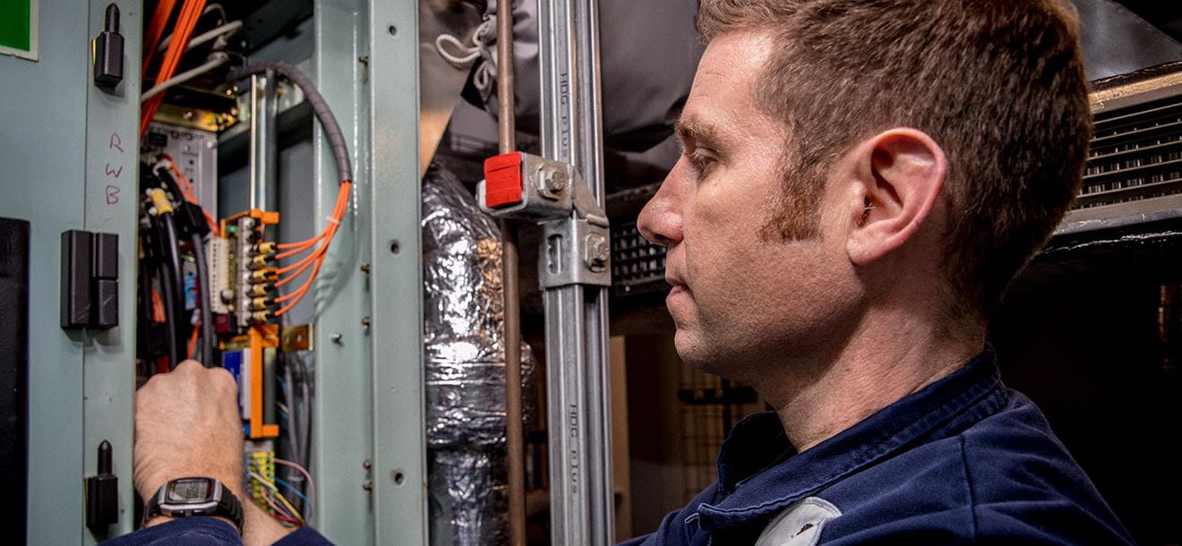 Members of HMS Queen Elizabeth’s Marine Engineering Department fix a defect on one of her propulsion drives.
