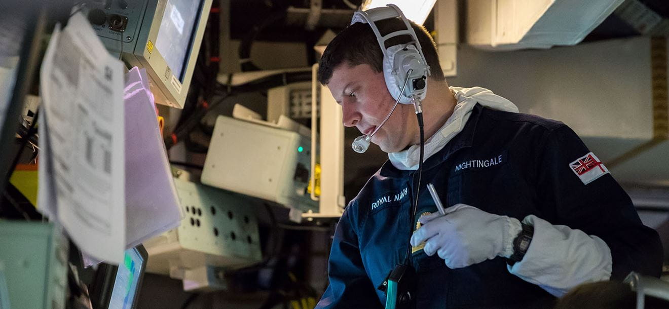 Principle Warfare Officer (PWO) Lieutenant Commander Nightingale at action stations in the Ops Room
