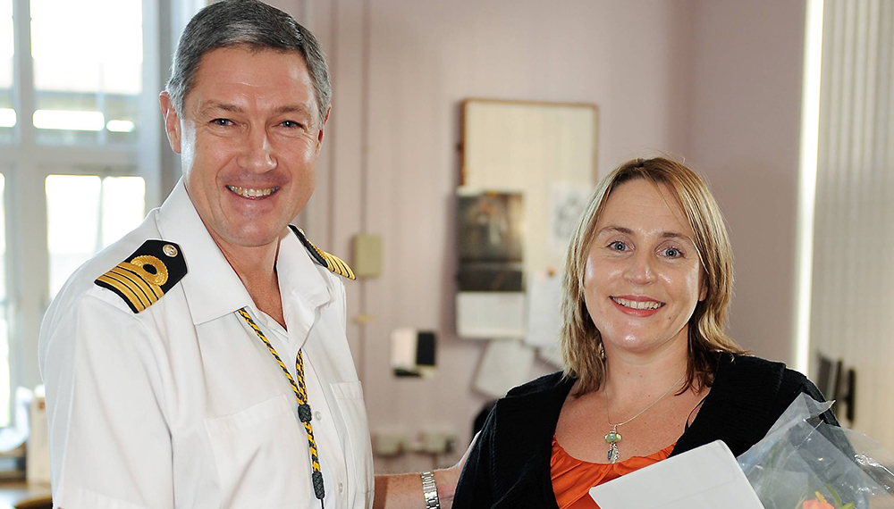 Royal-Navy-Our-People-Ops-for-all-07-life-after.jpg Lady being presented with flowers by senior Naval Officer