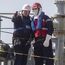 Royal-Navy-Our-People-Our-Values-16-teamwork.jpg RFA sailors in hard hats and life vests conduct replenishment at sea