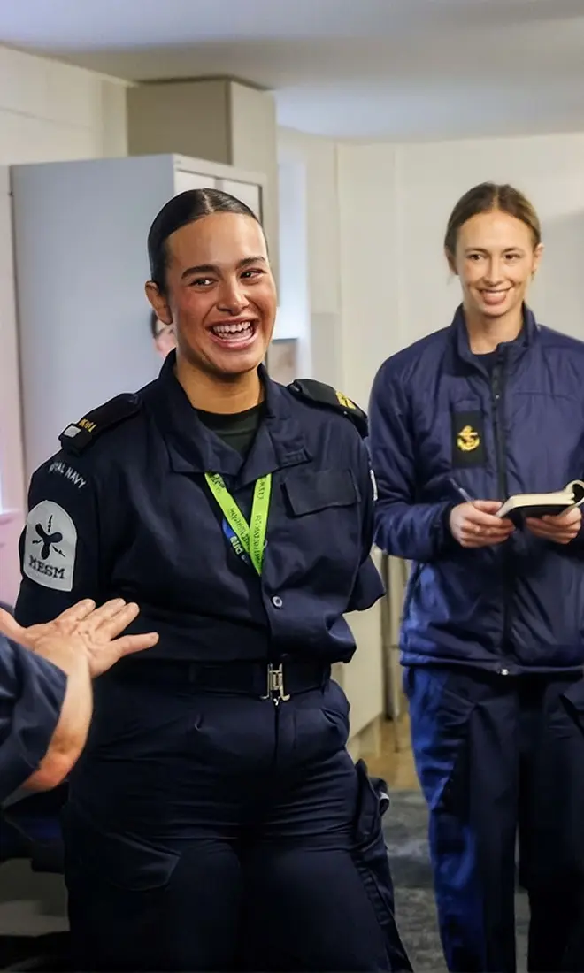 woman smiles and looks towards person behind camera
