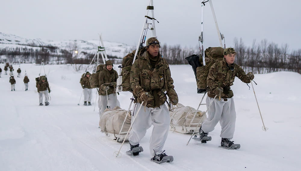 Pictured are Commando Forces yomping on snow shoes and carrying their skis on the extraction from the training area during their Cold Weather Winter Warfare Course near Skjold.