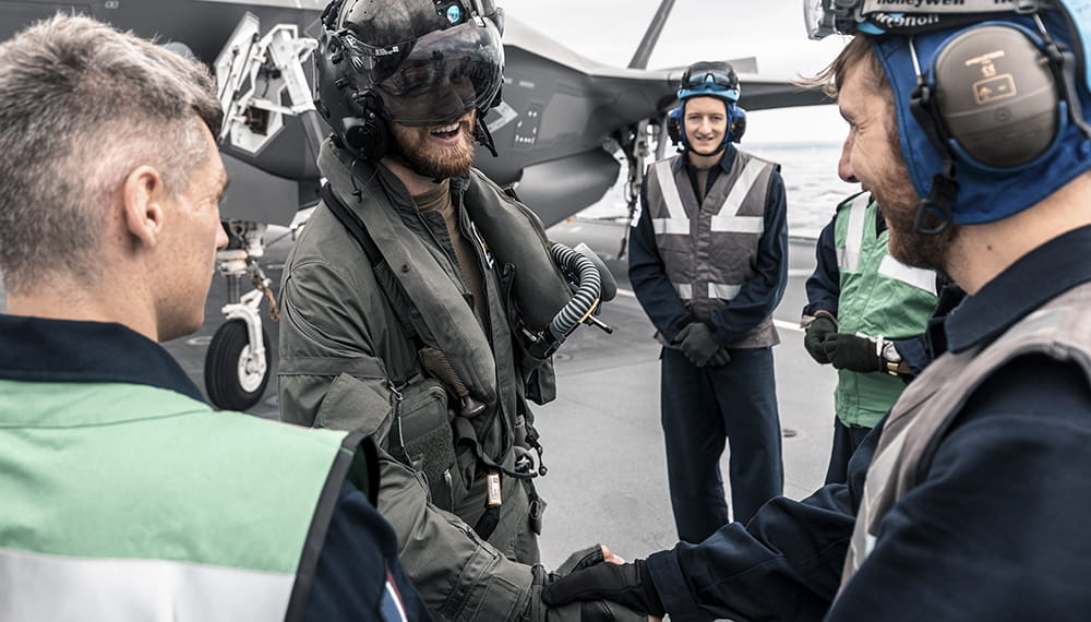 royal-navy-careers-fleet-air-arm-04 Personnel shake hands and smile. HMS Queen Elizabeth has embarked, for the first time UK F-35B Lightning II fighter jets during ‘WESTLANT 19’.