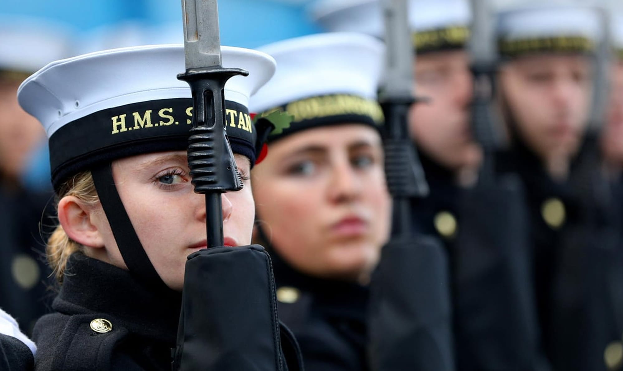 Personnel holding equipment wearing uniform in a line up