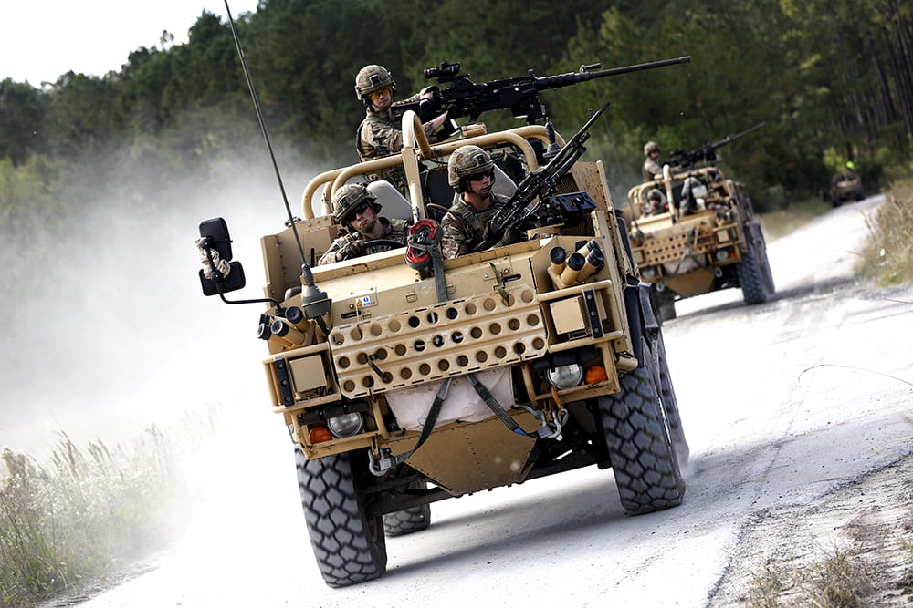Two Jackals driving towards camera wit a full compliment manning the guns