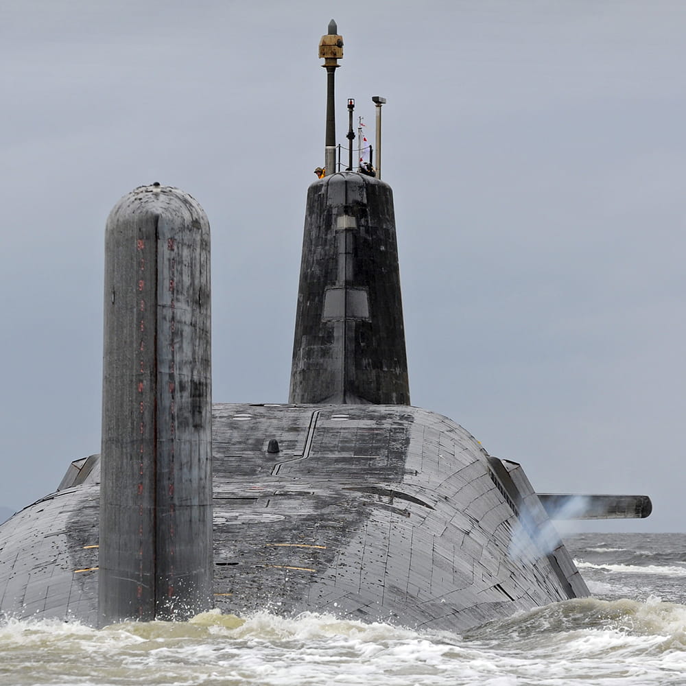 Vanguard Class submarine moves off with smoke venting from both sides of it's hull