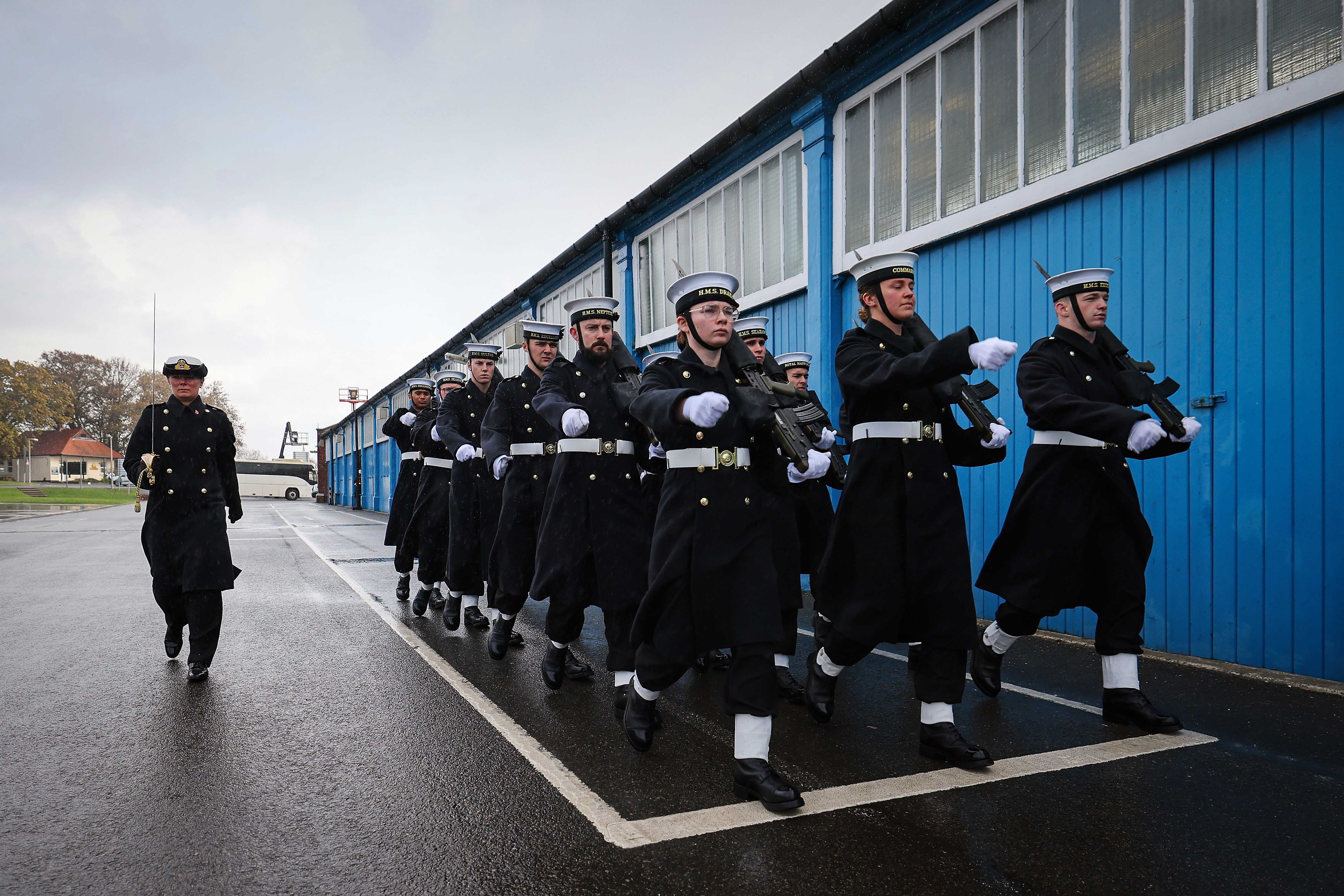 Officers and Ratings marching outside blue building at HMS Excellent