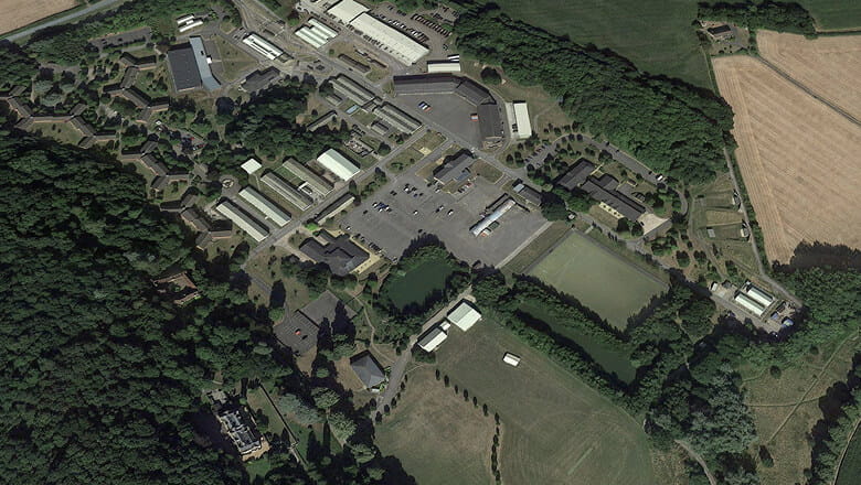 A colour photo shows a bird's eye view of the Royal Marines 40 Commando base. The small estate is surrounded by green countryside.
