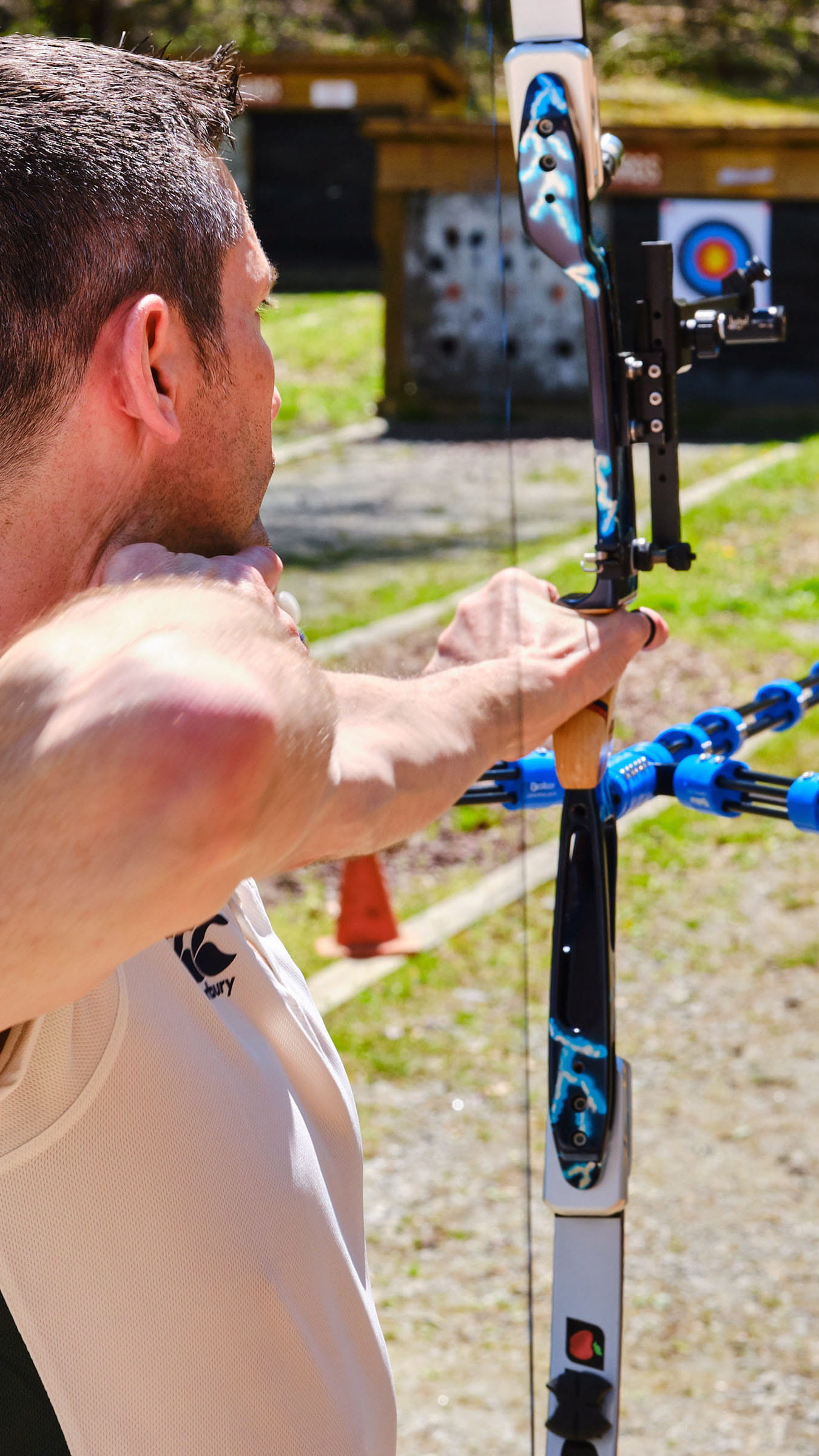 A person with a bow and arrow, aiming at a target.