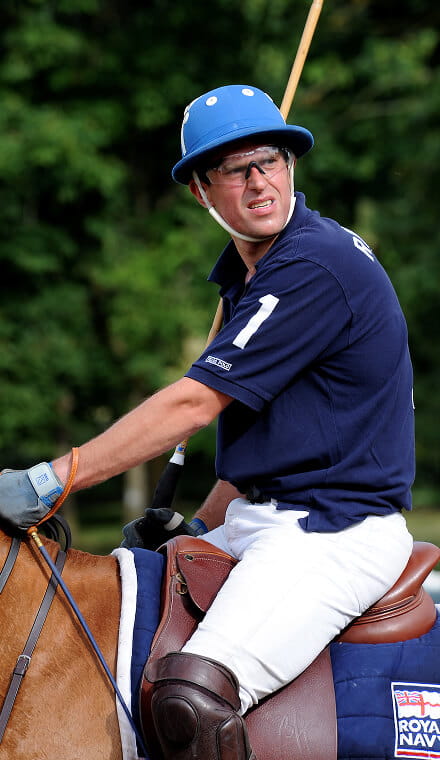 Man on a horse, wearing a Polo outfit and holding a Polo mallet