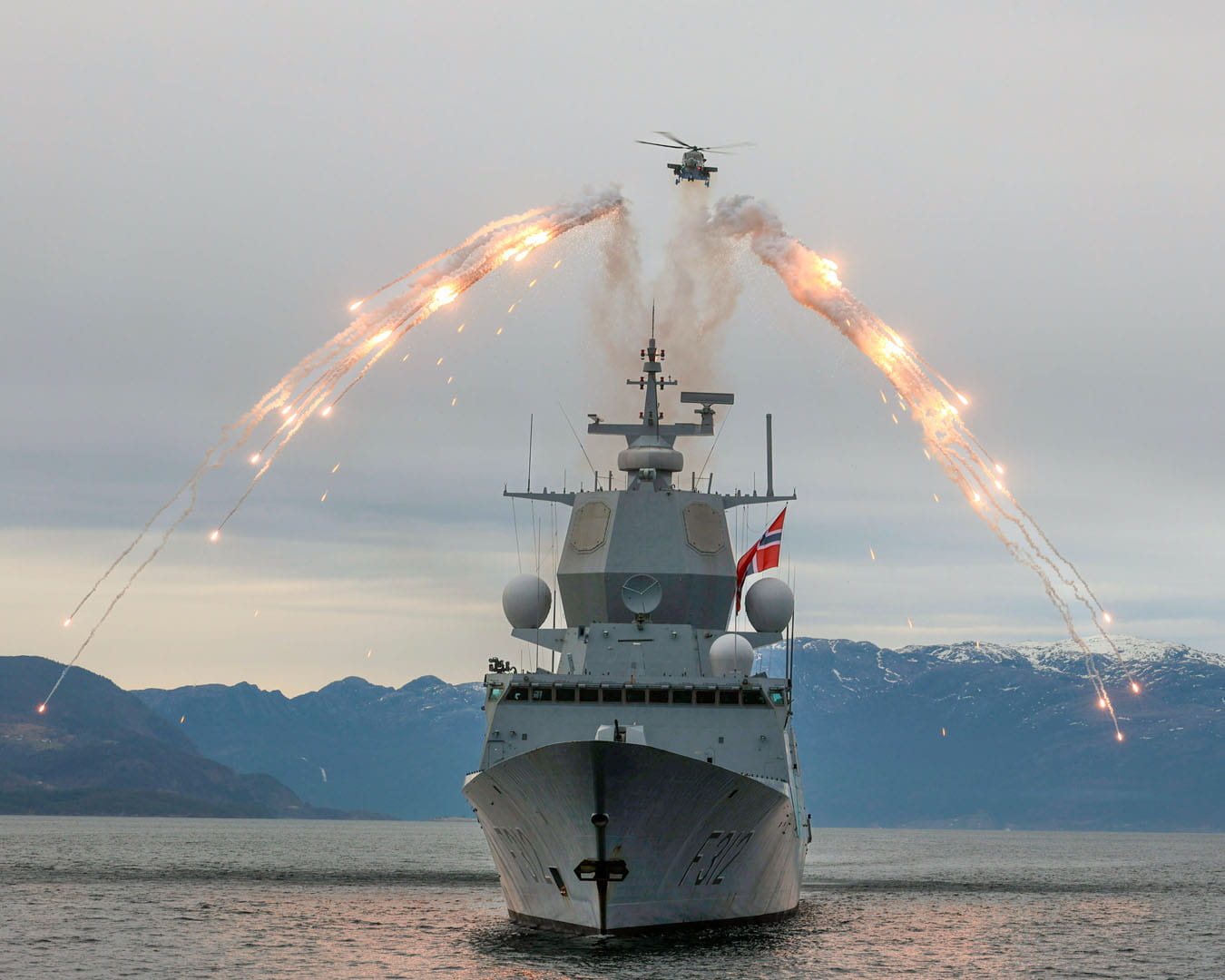 A Wildcat pumps out flares in an impressive display over HNoMS Sverdrup