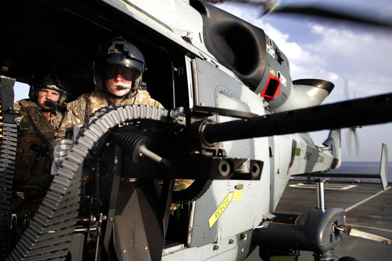 A sniper team from 42 Commando readies its weapon before take off in a Wildcat from RFA Lyme Bay