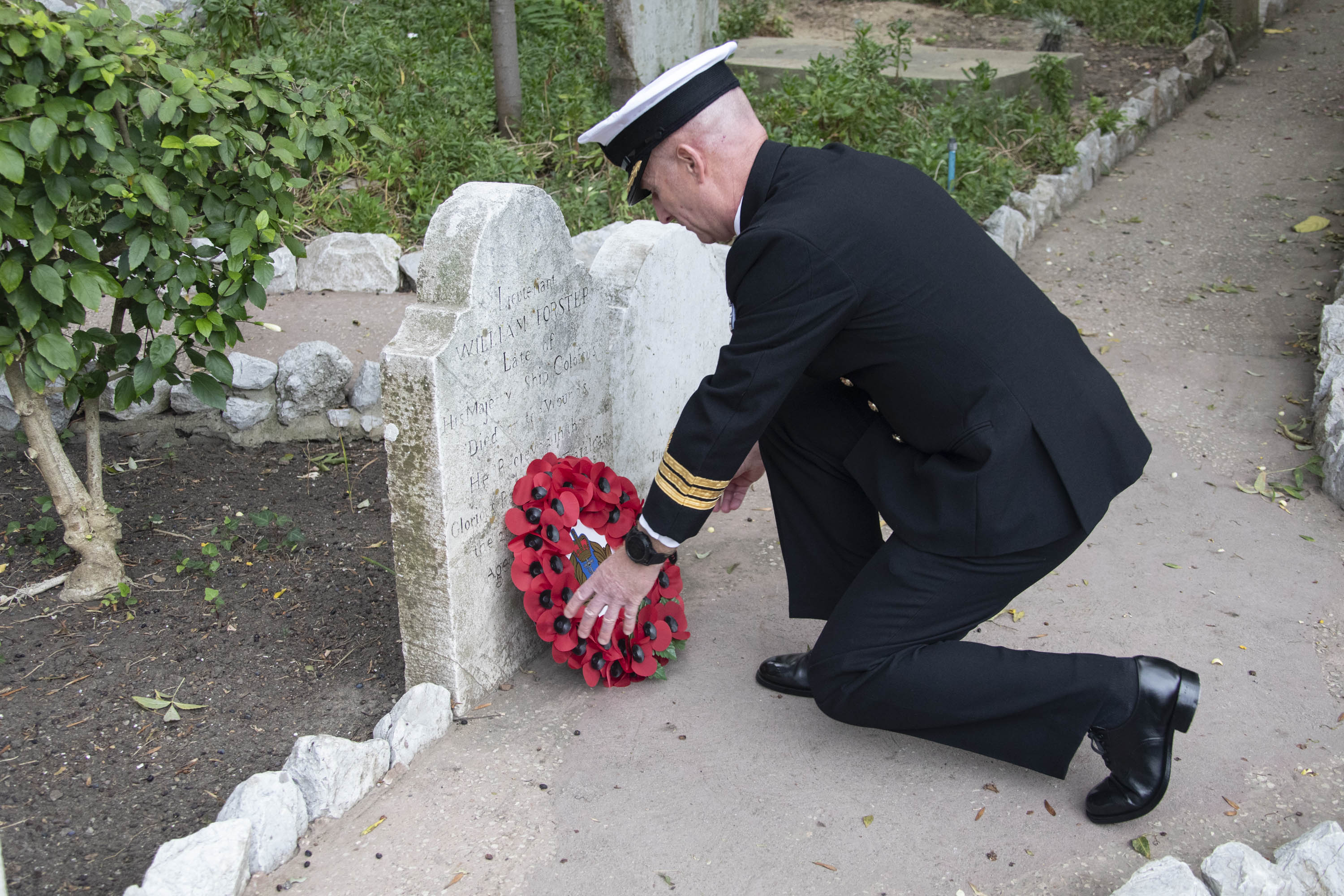 Commander Nick Baker places a wreath on the grave of a sailor killed at Trafalgar Commander Nick Baker places a wreath on the grave of a sailor killed at Trafalgar