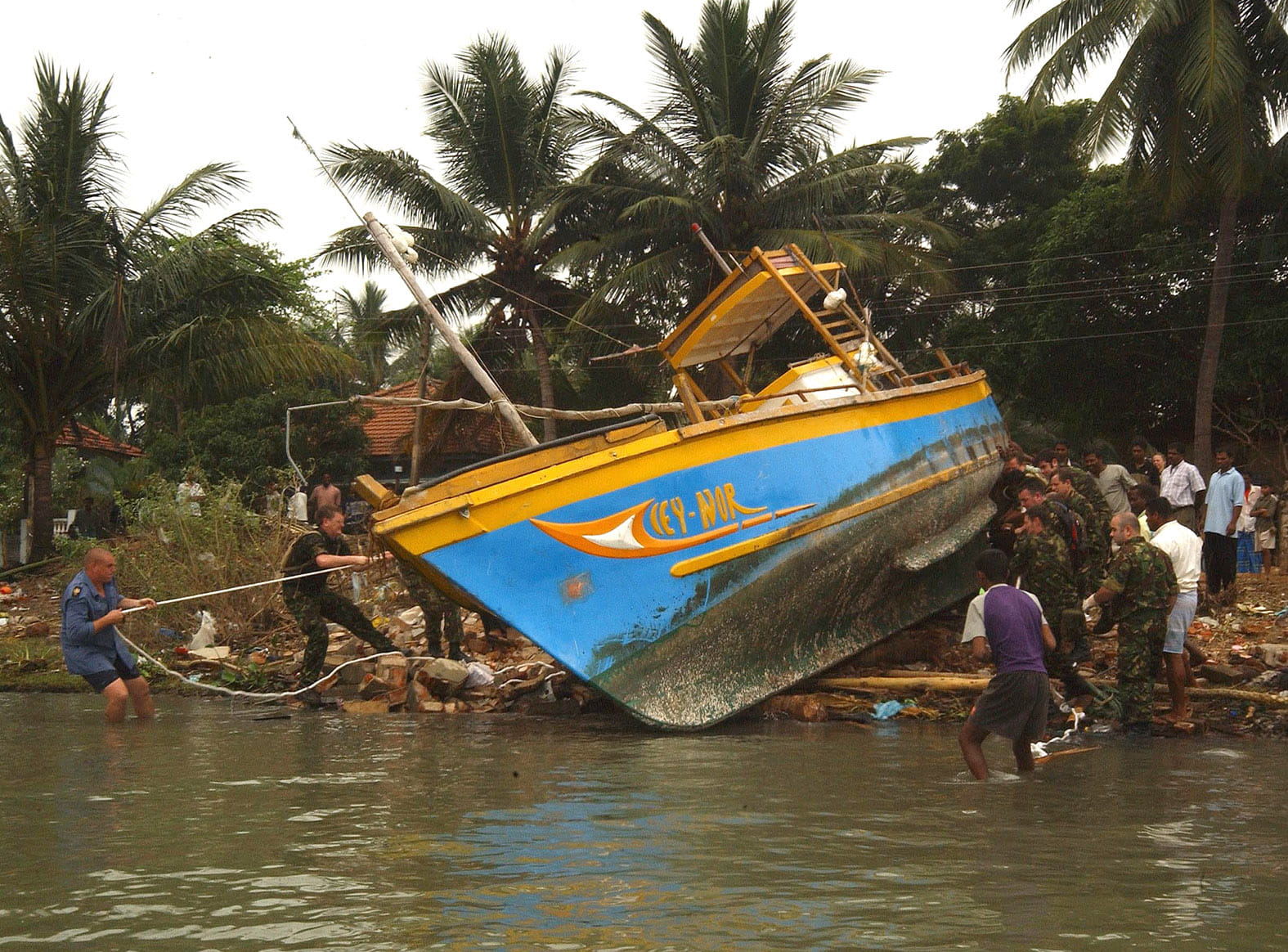 Royal Navy and RFA sailors help re-float a fishing boat swept 2km along the coast
