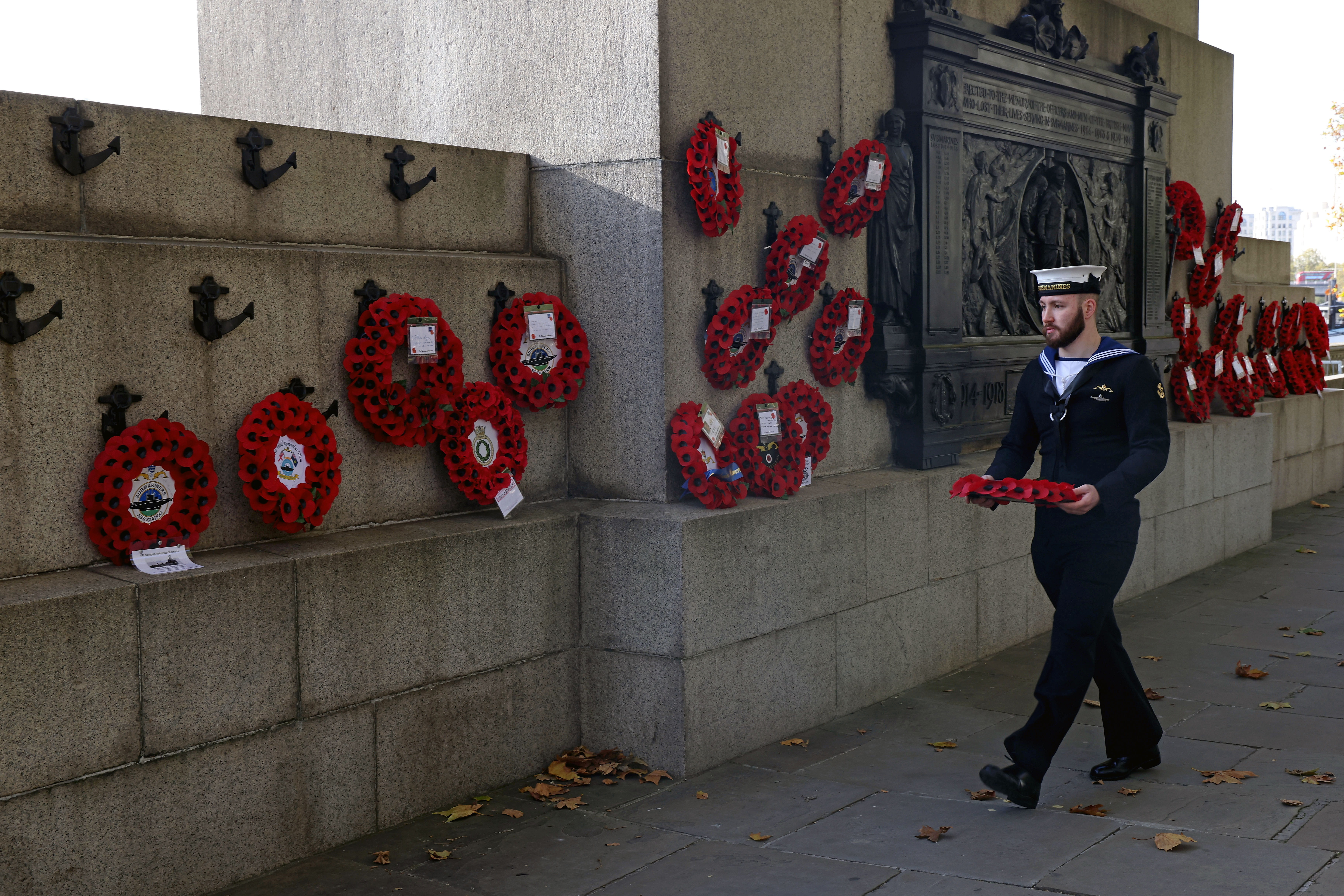 A serving submariner lays a wreath at the National Submarine War Memorial in London