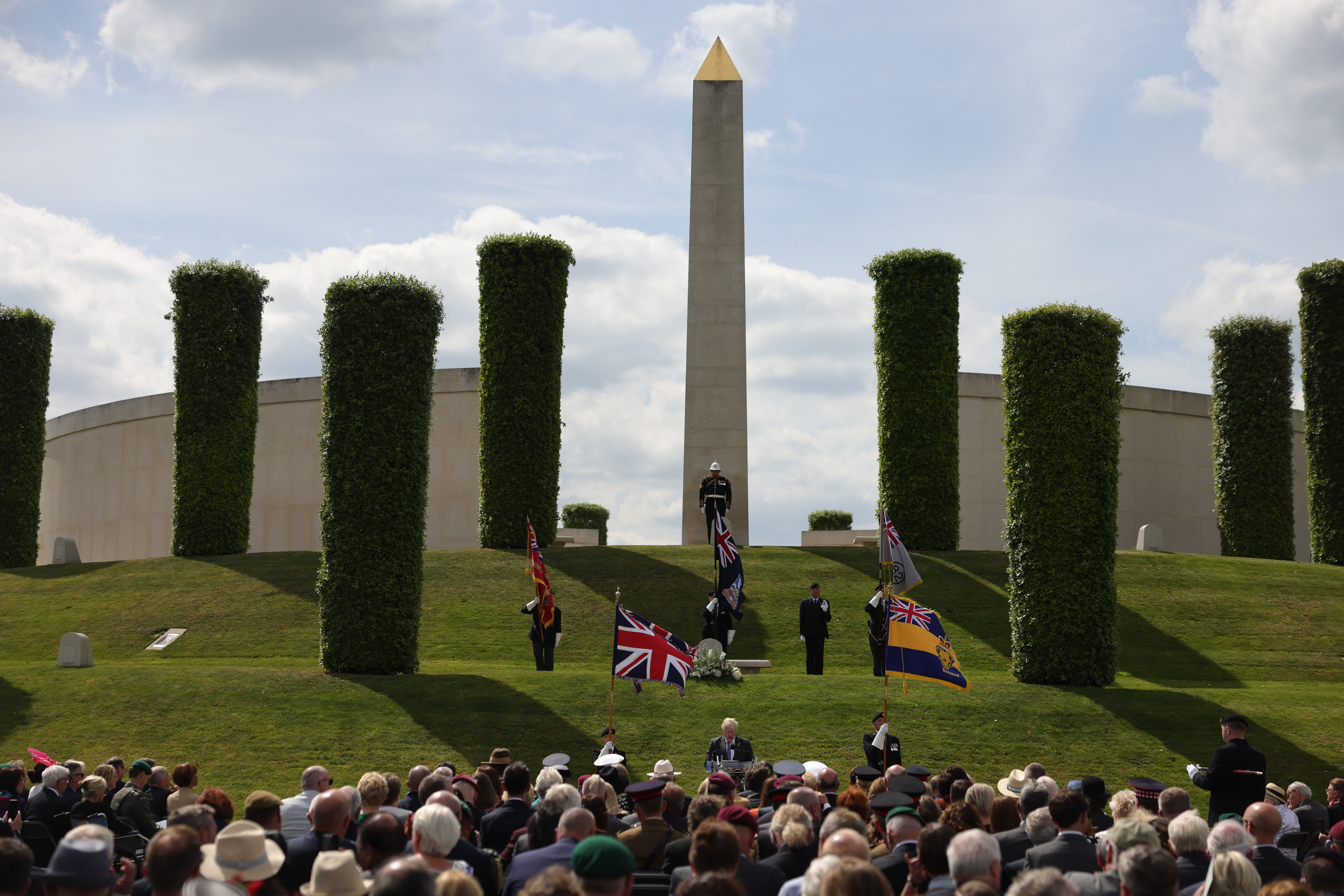 Veterans, families and VIPs gather in the shadow of the central memorial