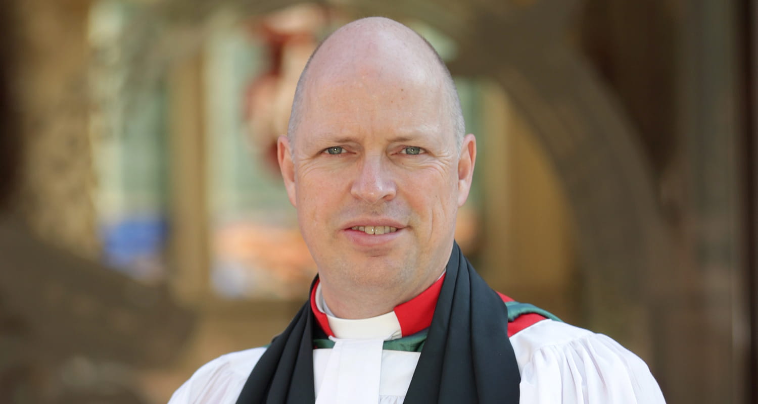Formal portrait of The Reverend Martyn Gough QHC Outside St Ann's Church, Portsmouth Naval Base