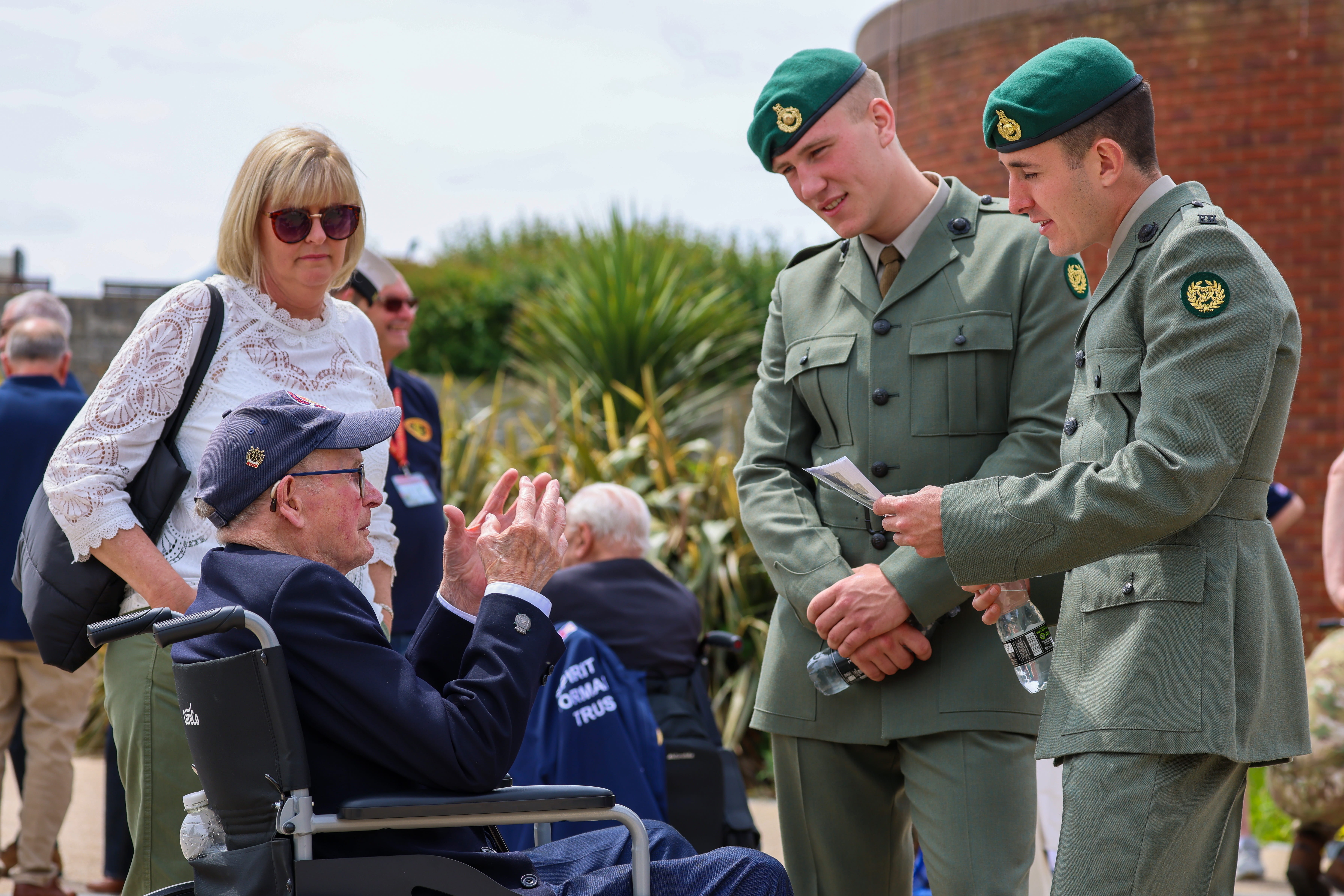 A couple of Royal Marines in lovats from 47 Commando chat with a Normandy veteran A couple of Royal Marines in lovats from 47 Commando chat with a Normandy veteran