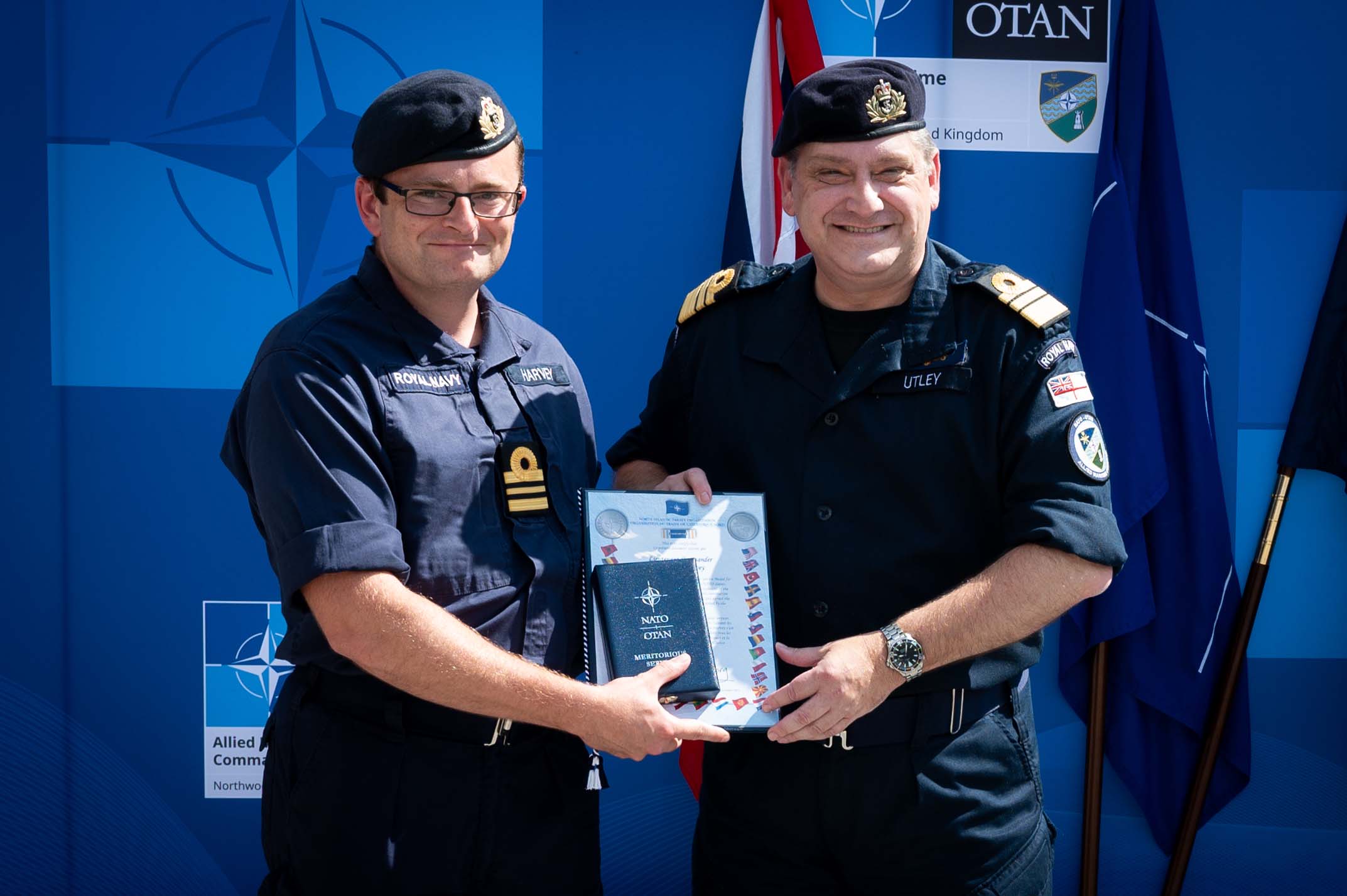 Lt Cdr Matt Harvey receives his NATO medal from Vice Admiral Mike Utley