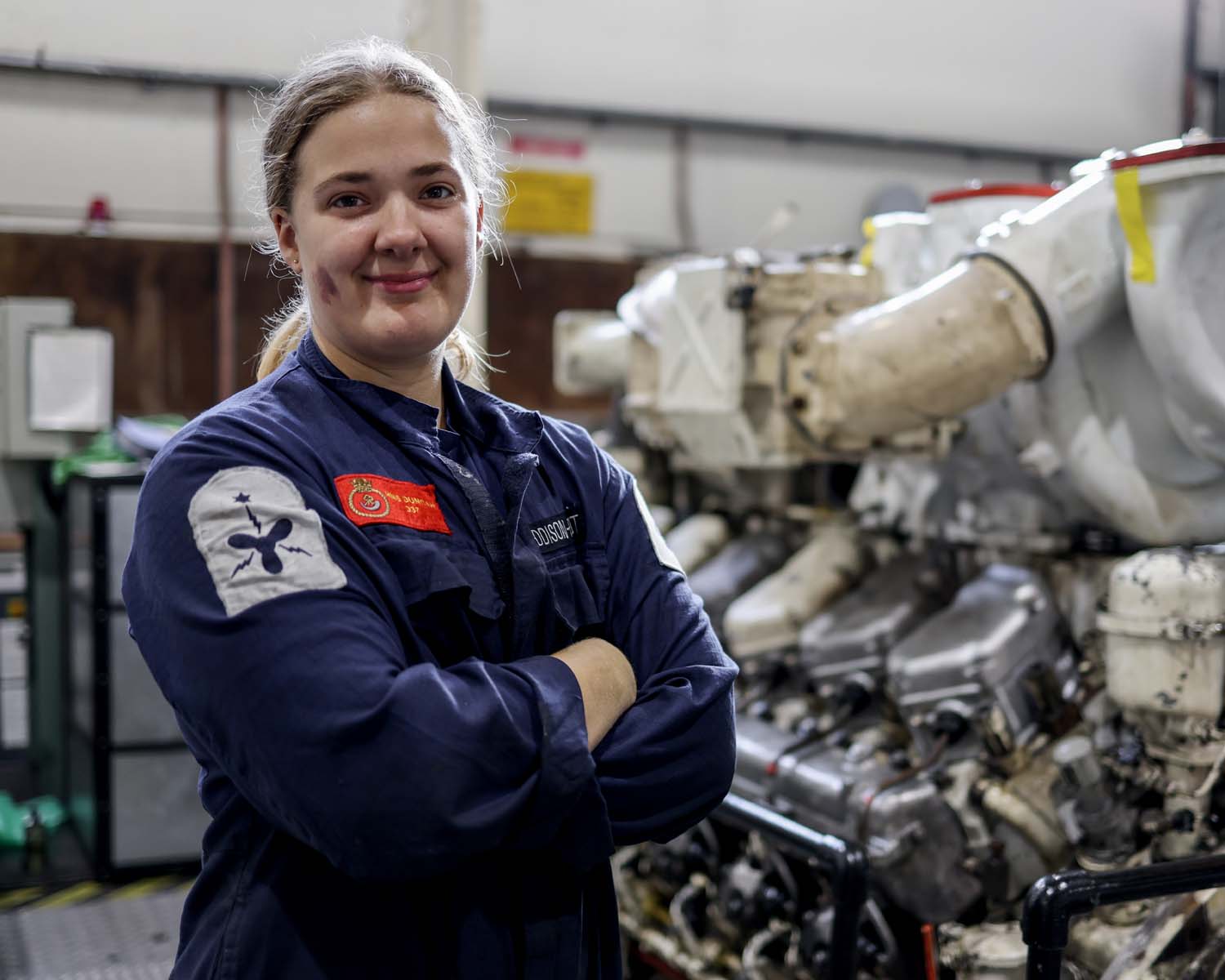 A female engineer smiles and poses for the camera