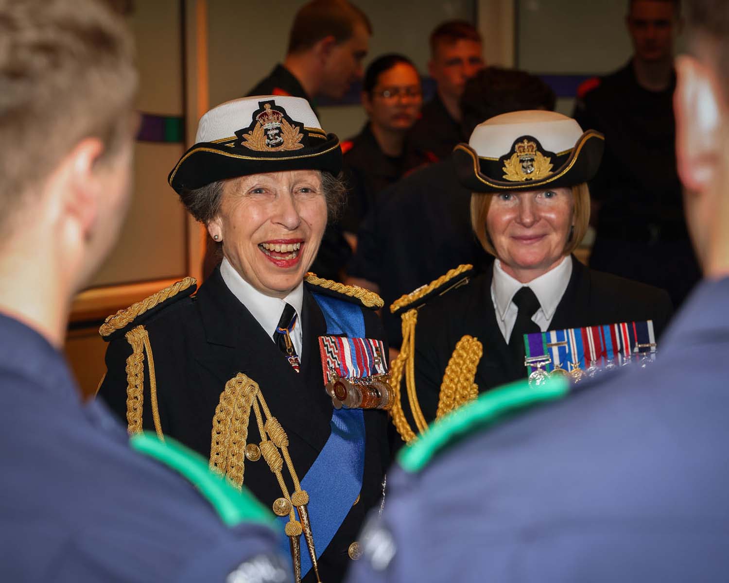 Two recruits share a light hearted moment with the Princess Royal