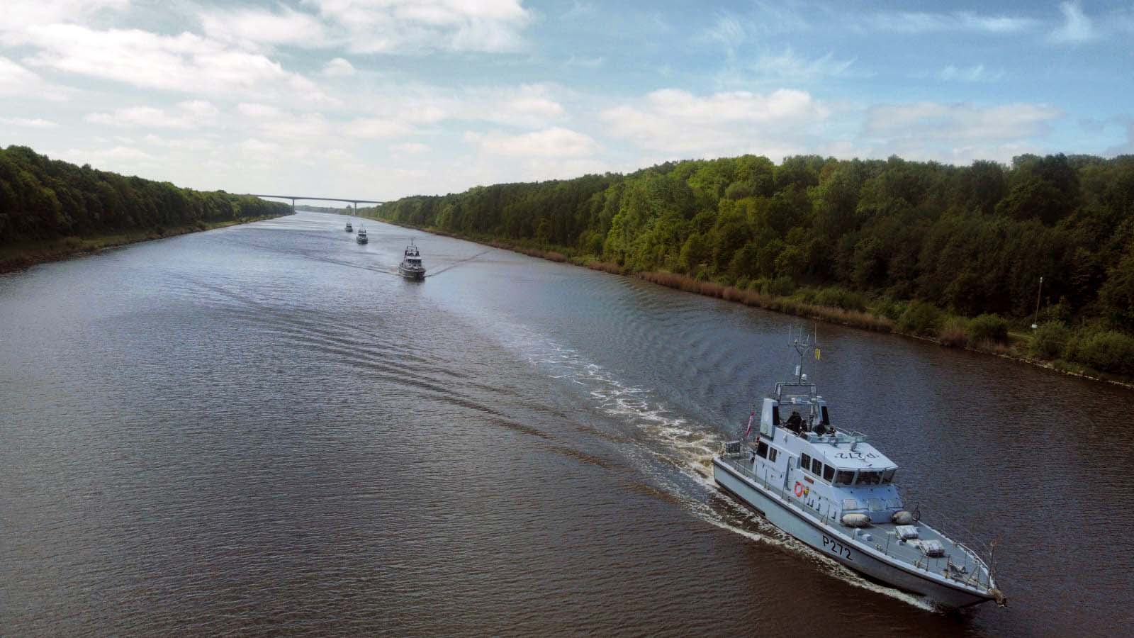 HMS Smiter leads three P2000s through the Kiel Canal