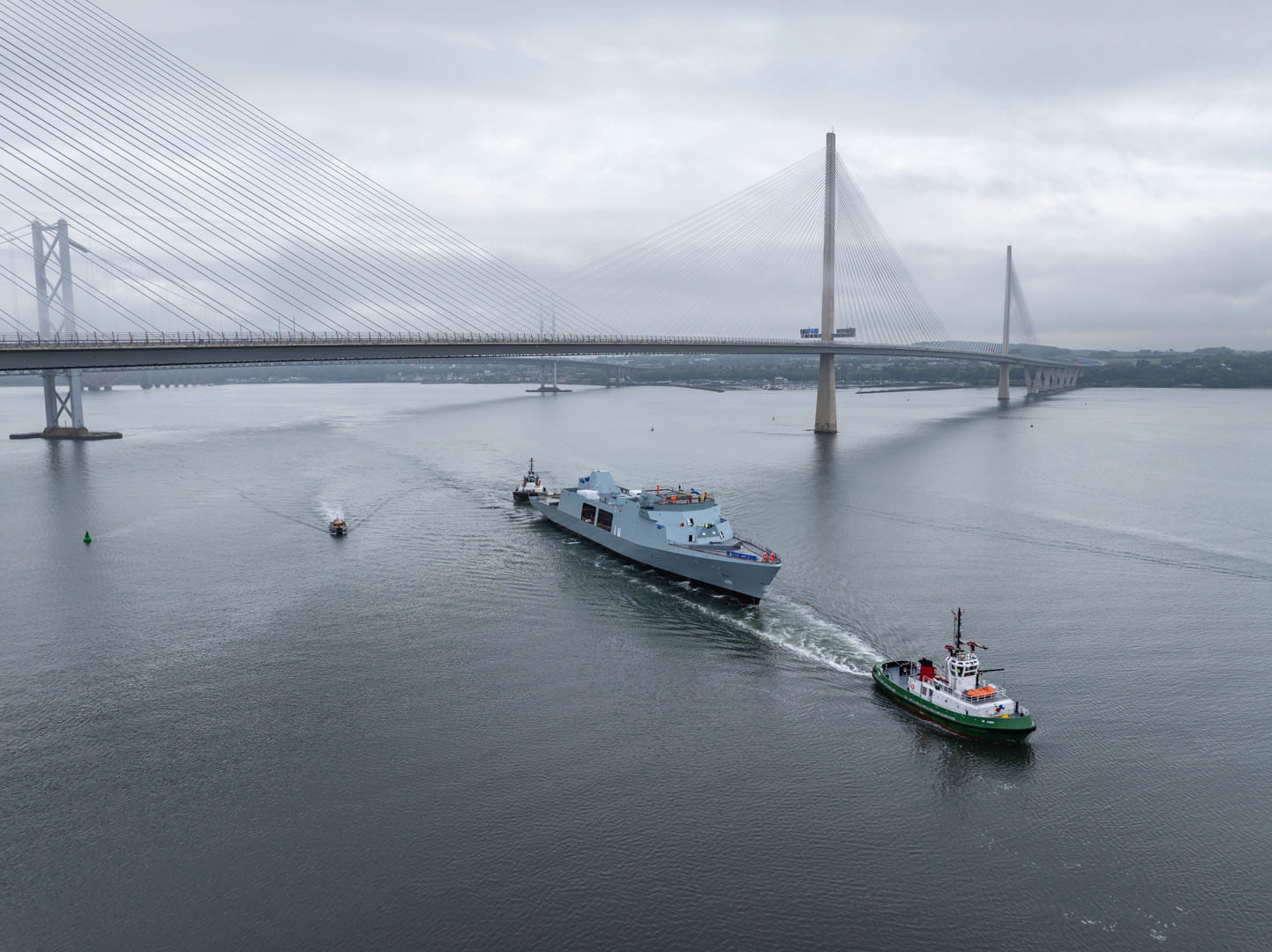 Tugs haul HMS Venturer past the two Forth road crossings