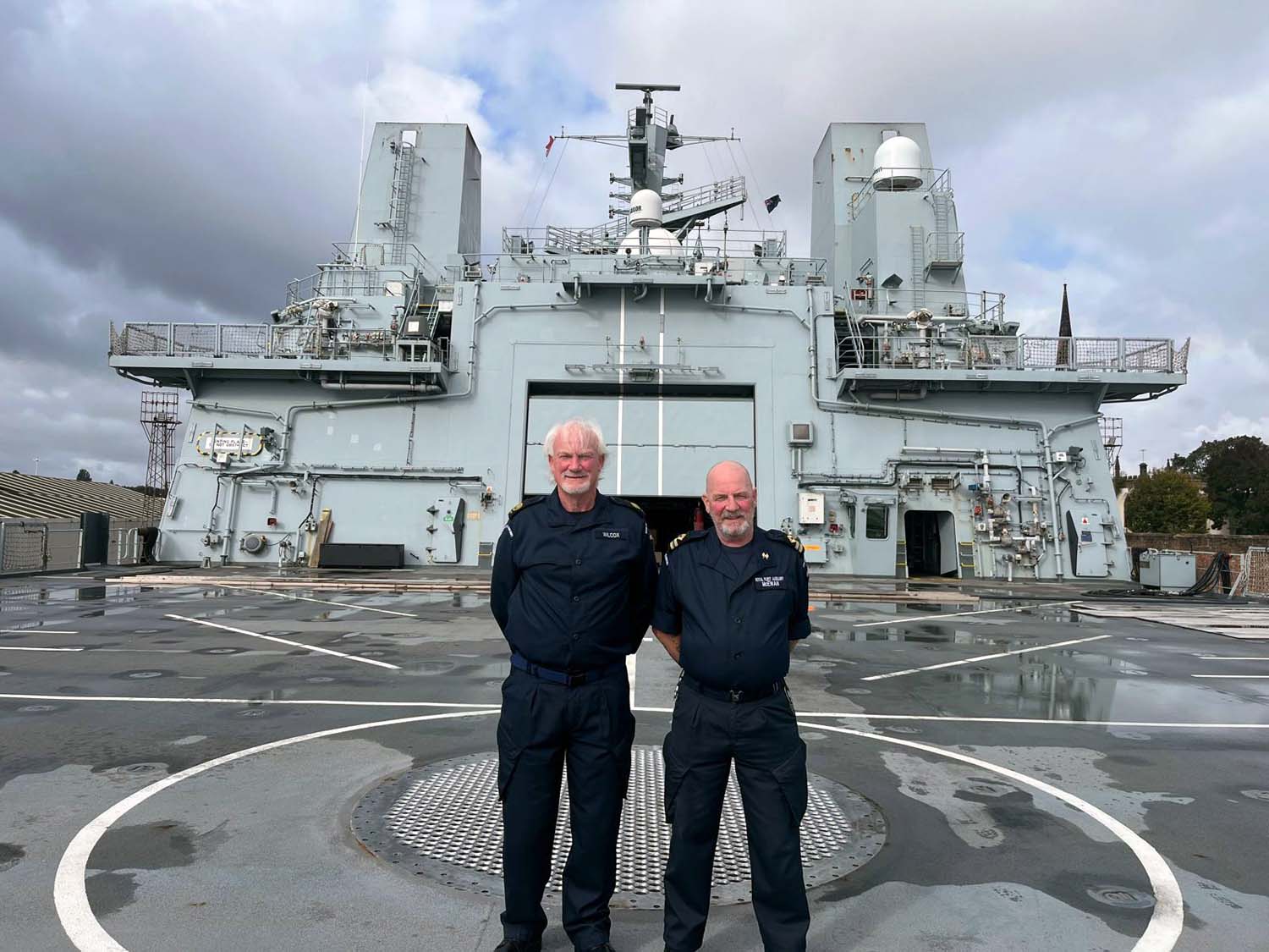 Graham McEwan (left) and Paul Wilcox on the bridge wing with RFA Tidesurge in the distance