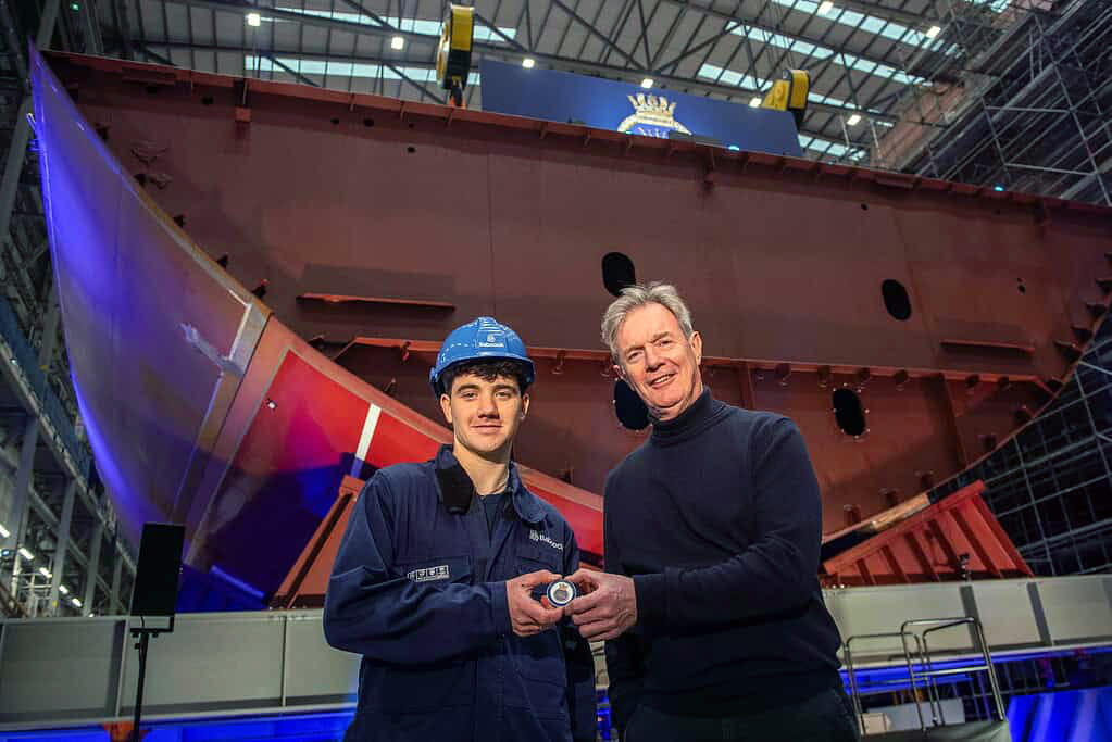 Apprentice Joolz Hunter and Babcock CEO Sir Nick Hine with the commemorative coin to be placed under