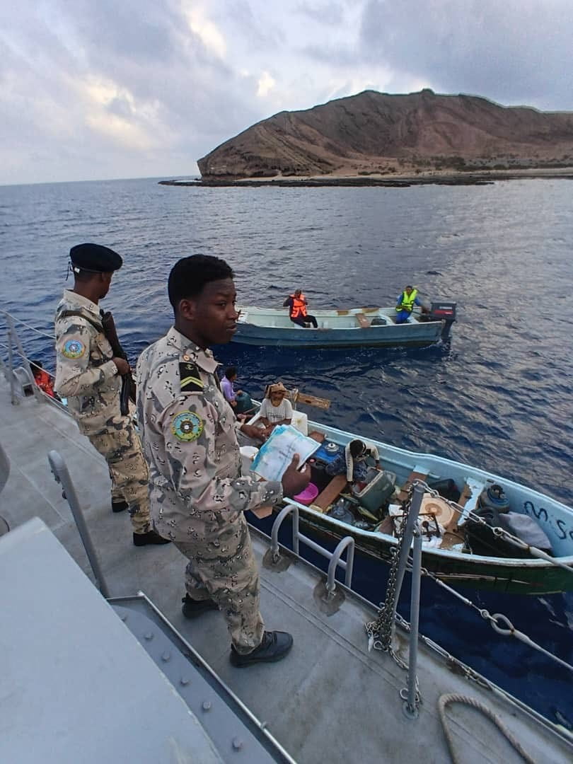 Two Djibouti Coast Guard personnel check on local fishermen