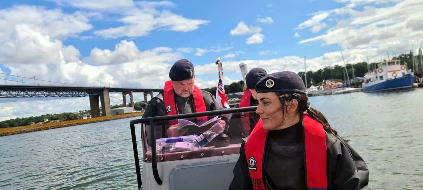 Petty Officer Warnock consults a textbook while delivering training