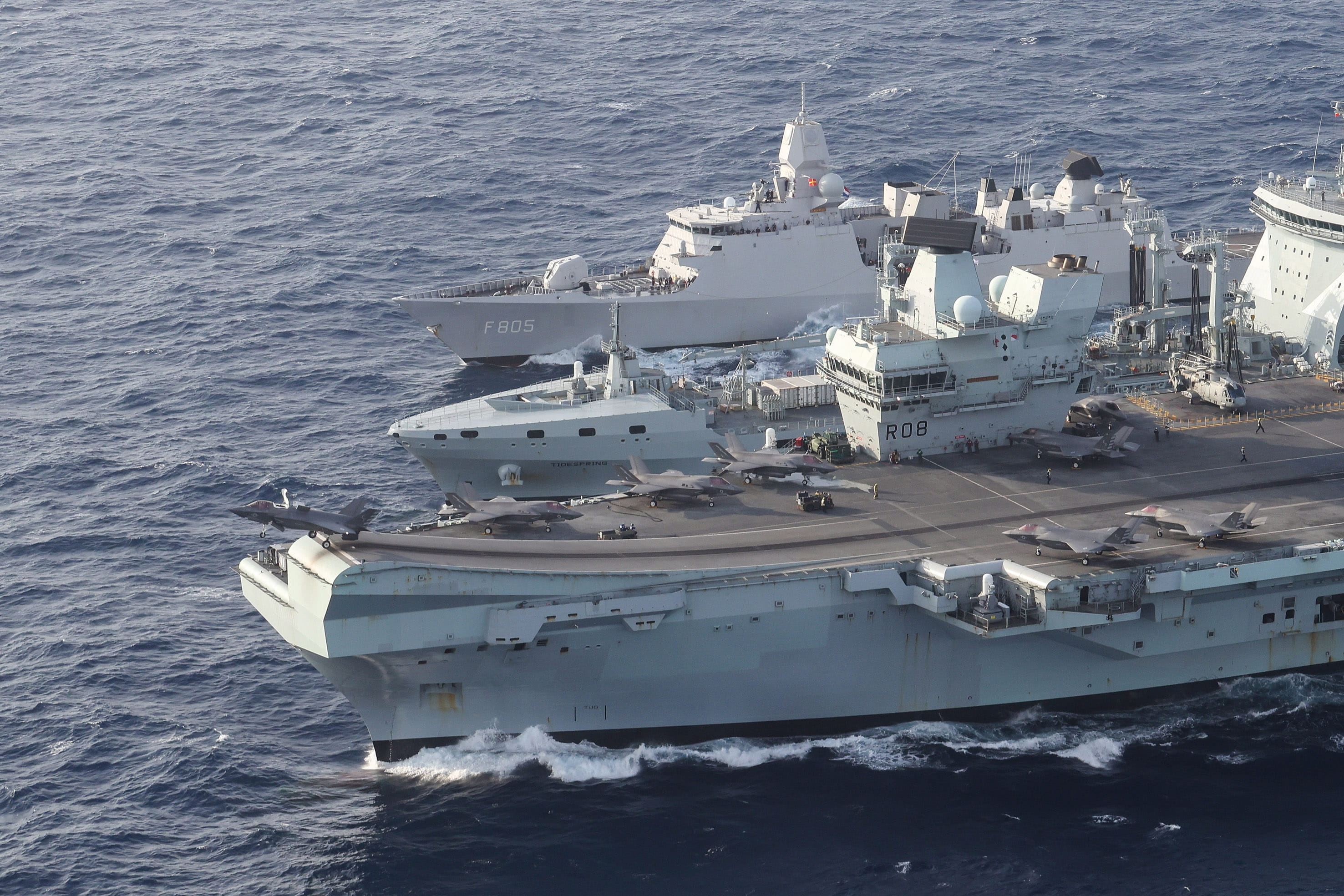 An F-35B is launched by HMS Queen Elizabeth as she and the Evertsen take on supplies from RFA Tidespring