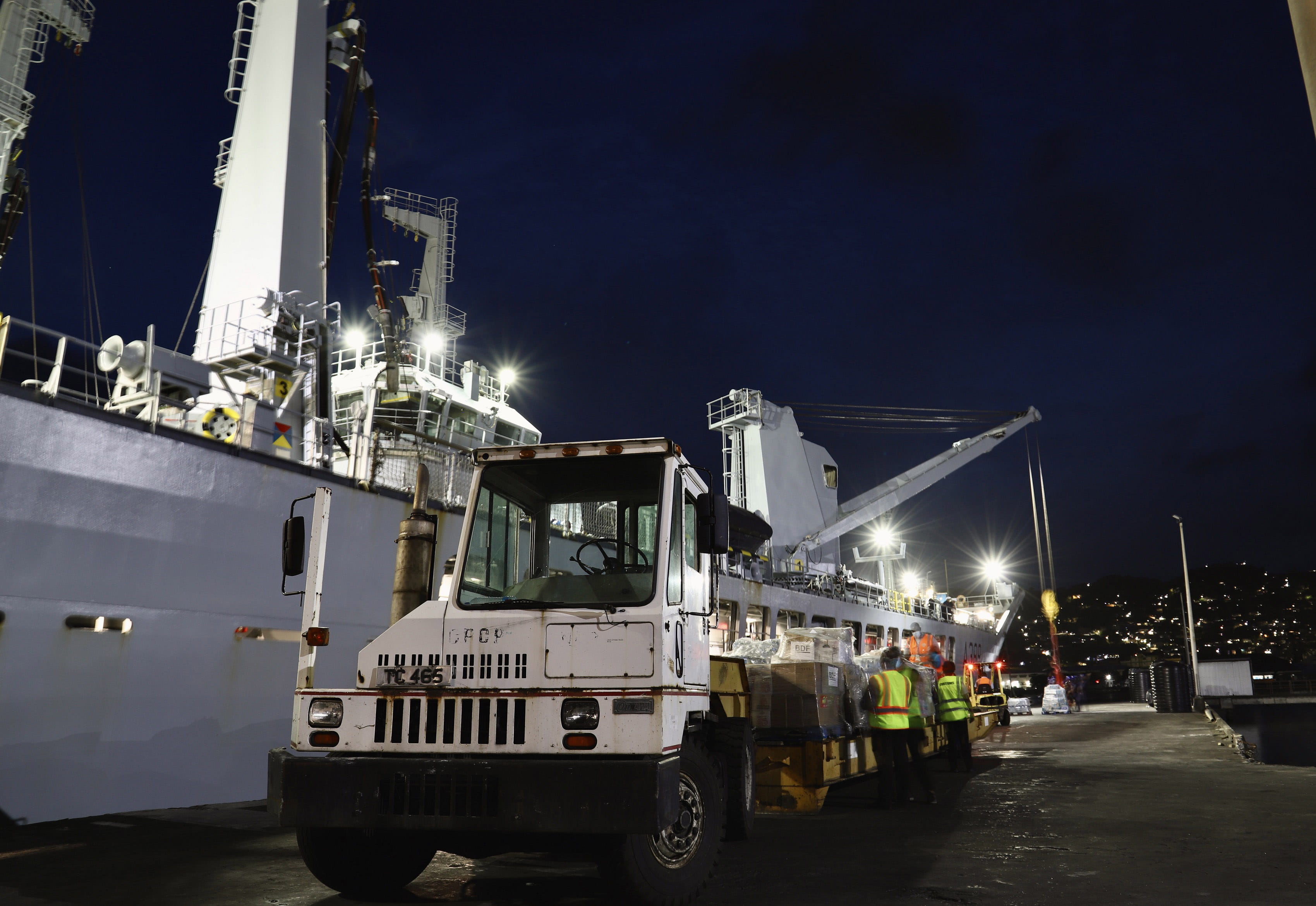 A low loader is loaded with aid from Barbados delivered by RFA Wave Knight