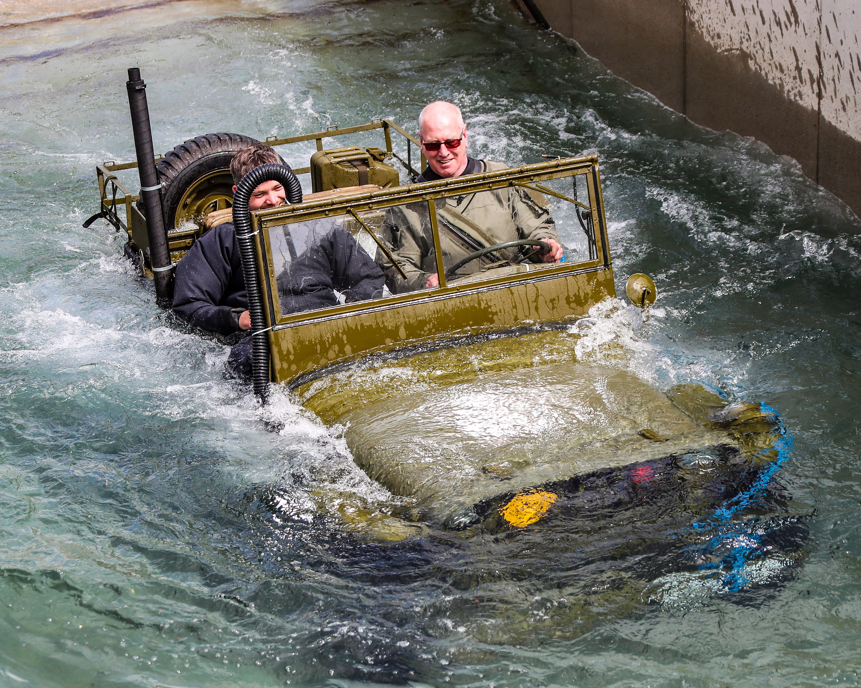 World War Two Willys jeep is driven through the dip tank at RM Instow. Picture: Paul Hall