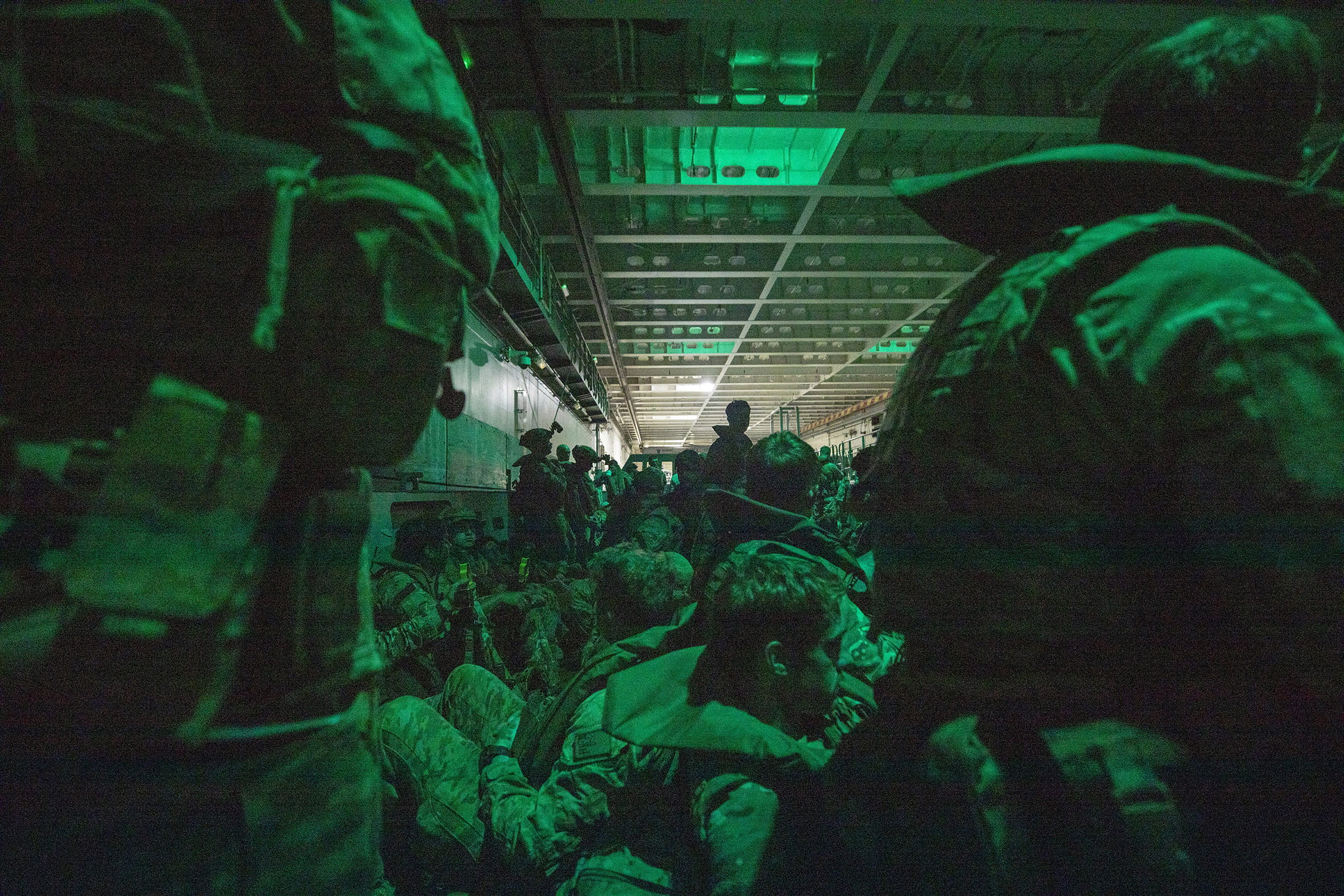 Men of 40 Commando are packed in an Australian landing craft ready for the dawn raid at Forrest Beach