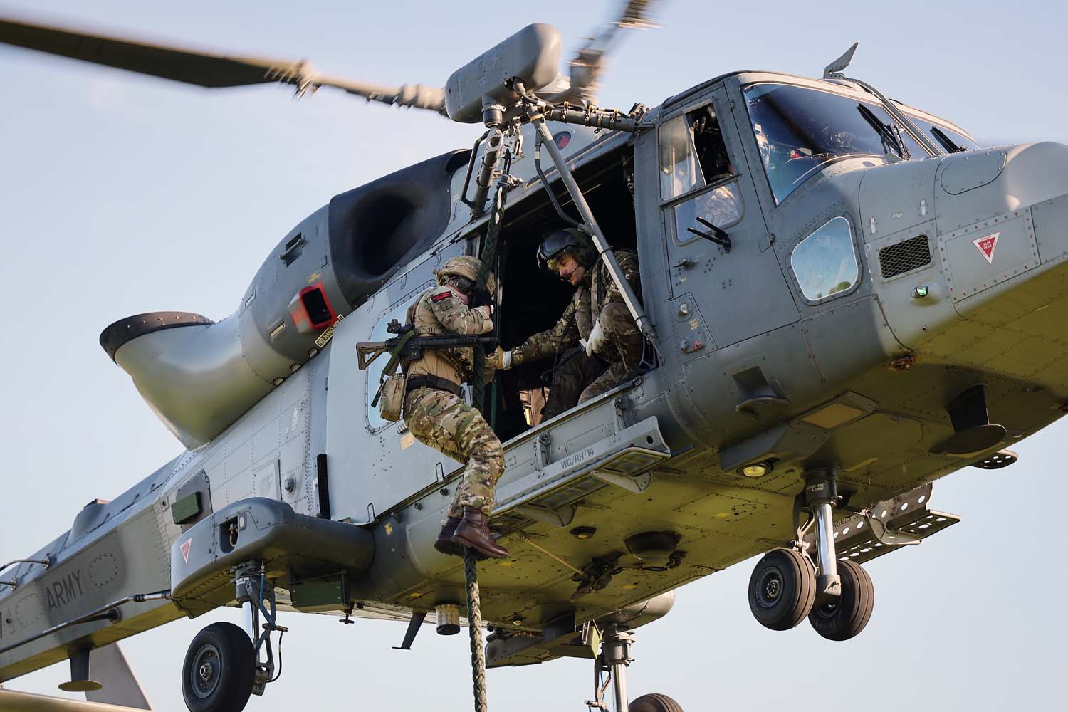 Royal Marines fast rope from a Wildcat