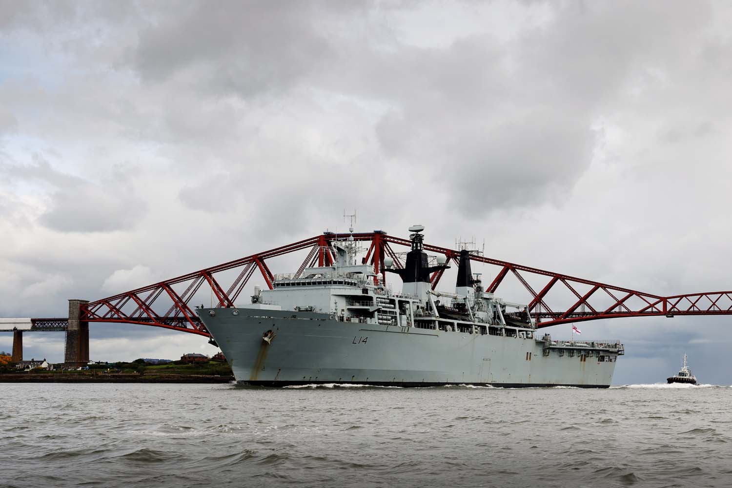 HMS Albion passes under the Forth Rail Bridge as she enters harbour at Crombie harbour.
